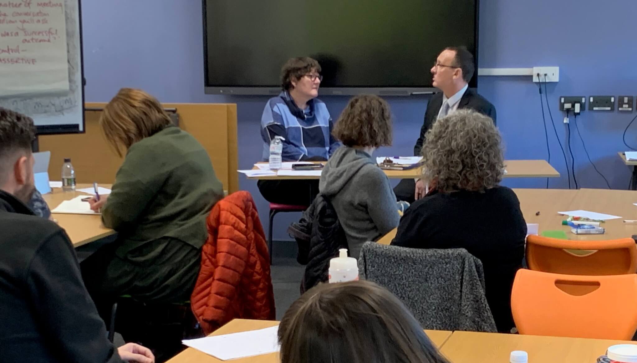 Participants of Managing Performance Training at Coleg-y-Cymoedd watch a scenario by Lorraine Simms and Rob Joiner