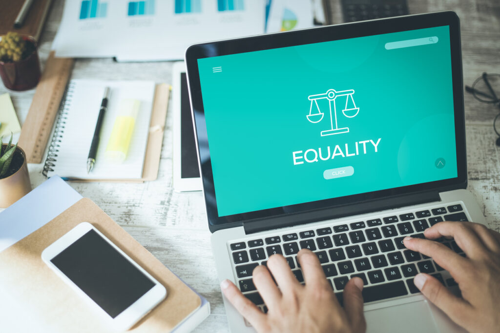 Laptop showing the words Equality under a set of scales